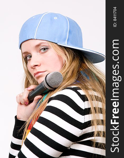Pretty female with microphone isolated