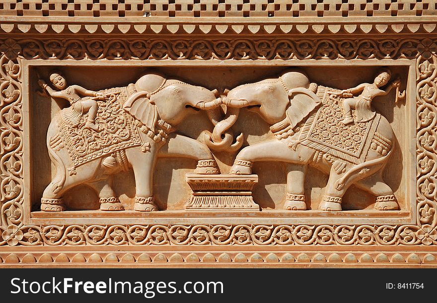 Fine sculptures of men riding elephant on marble wall