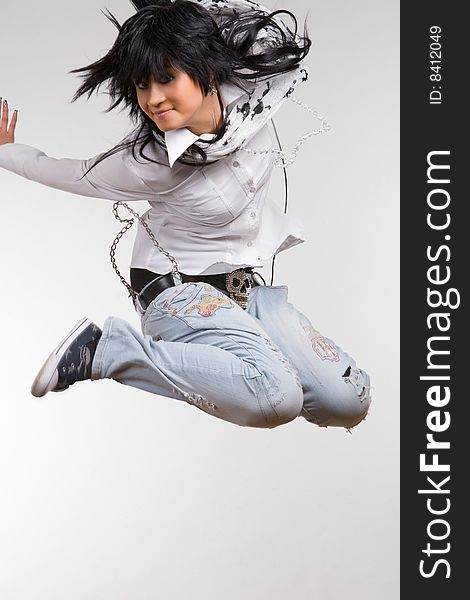 Attractive brunette jumping with headphones. Attractive brunette jumping with headphones
