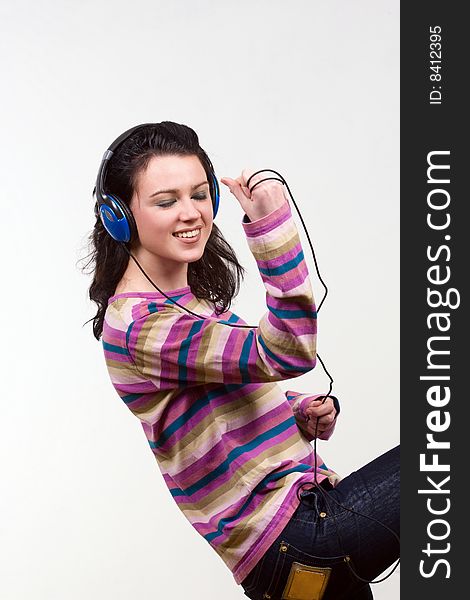 Attractive young woman with headphones over white background