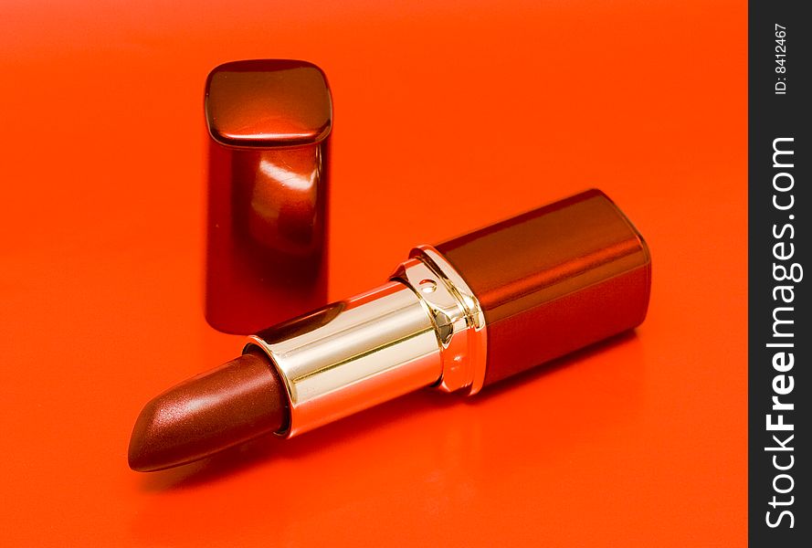 Lipstick tube on red background