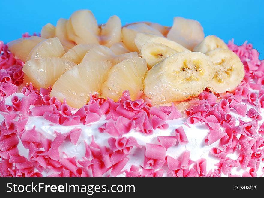 Closeup of cake with fruits on blue background