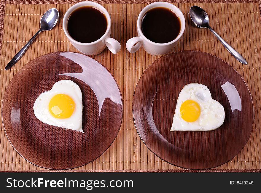 Fried eggs and two cups of black coffee. Fried eggs and two cups of black coffee