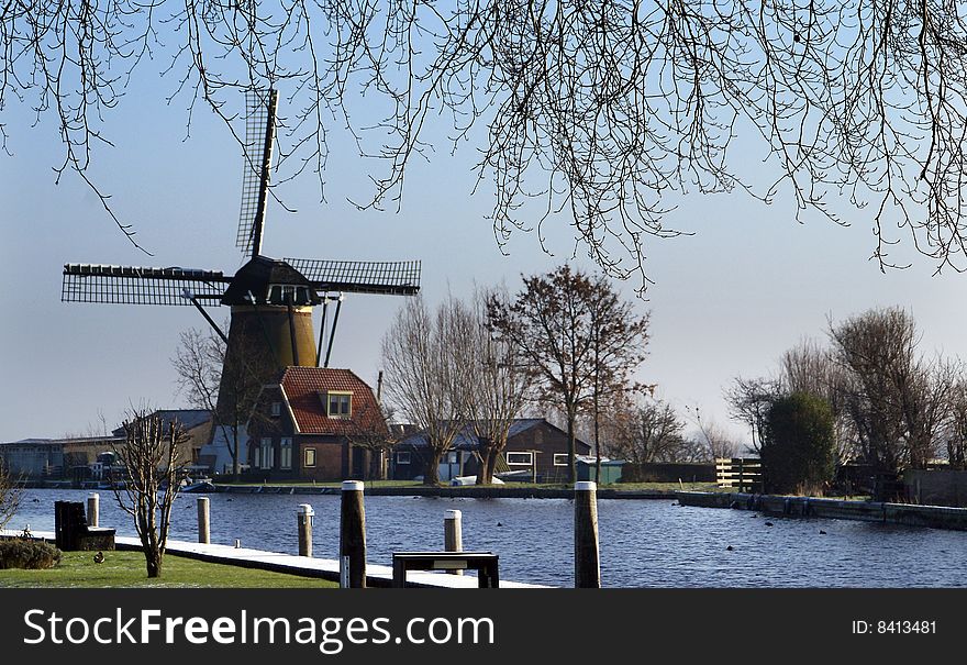 Typical Dutch view, windmill alongsite a canal. Typical Dutch view, windmill alongsite a canal