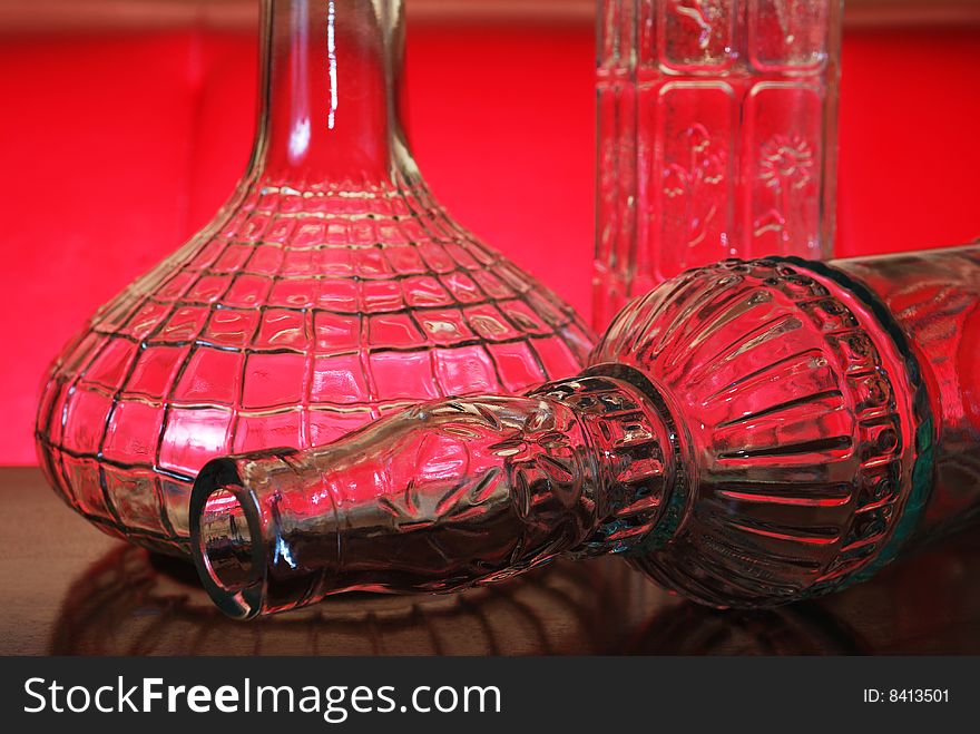 Closeup of decorative bottles on red background