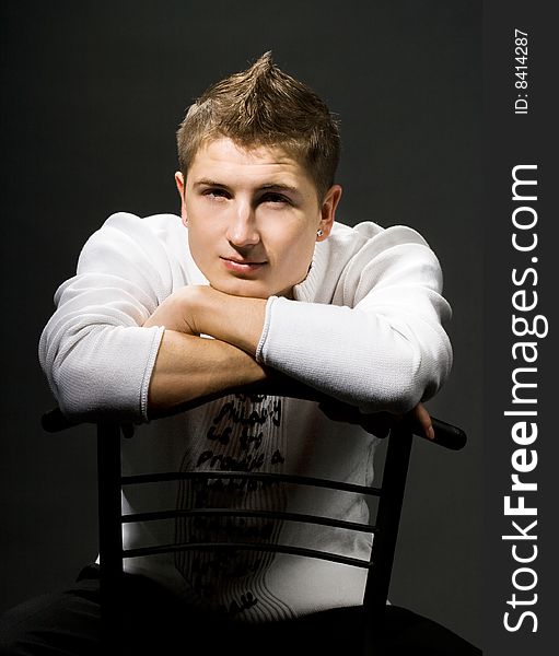 Attractive modern man sitting on a chair