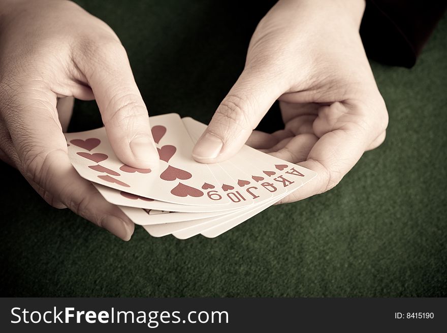 Gambler holding the perfect hand (Ace, King, Queen, Jack, Ten and Nine of hearts). Gambler holding the perfect hand (Ace, King, Queen, Jack, Ten and Nine of hearts)