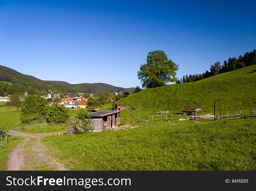 Summer agriculture Landscape with village and blue sky. Summer agriculture Landscape with village and blue sky