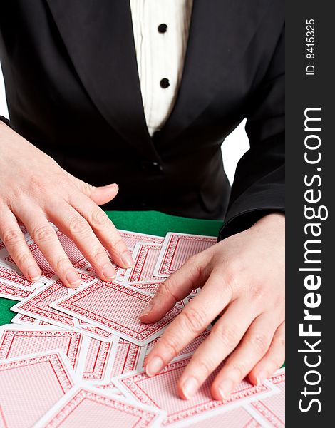 Croupier mixing playing cards on a  table. Croupier mixing playing cards on a  table