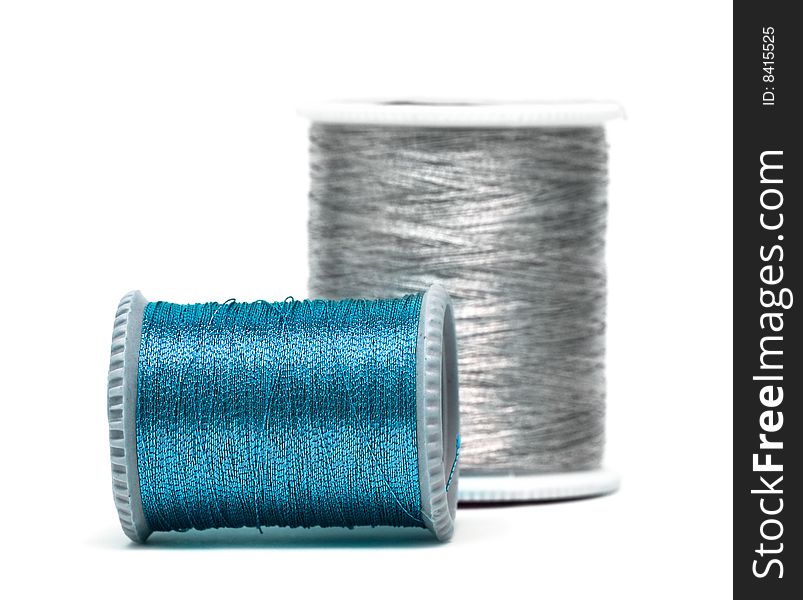 Blue and silver spools of threads