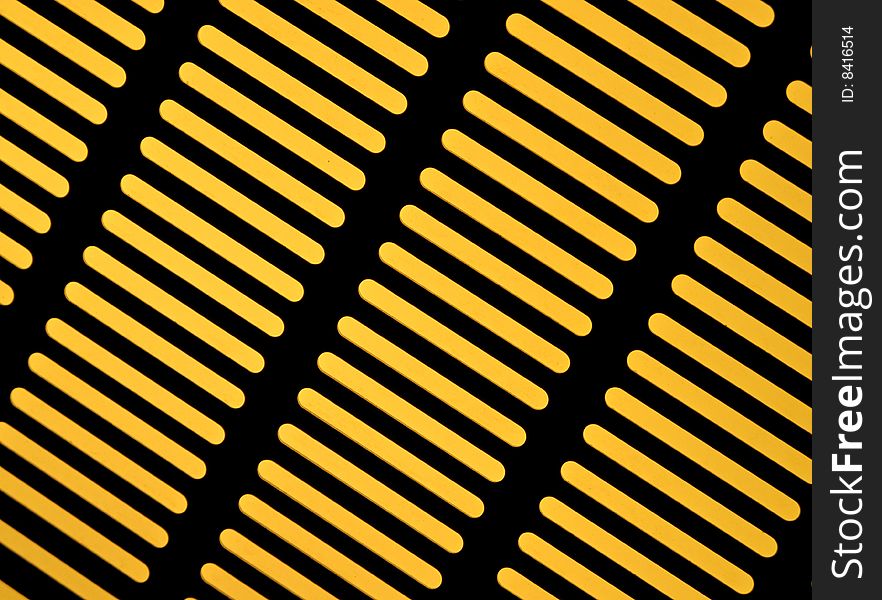 Steel grill covering a yellow light source. Steel grill covering a yellow light source