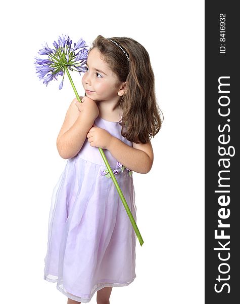 Pretty young girl in a dress holding a large purple agapanthus. Pretty young girl in a dress holding a large purple agapanthus.