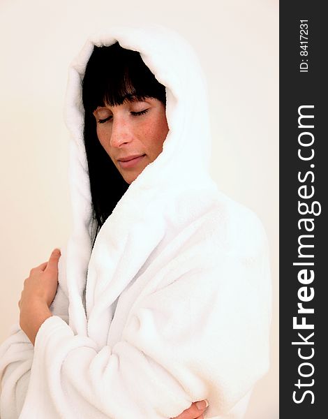 Girl in wool bathrobe with blackhair and closed eyes