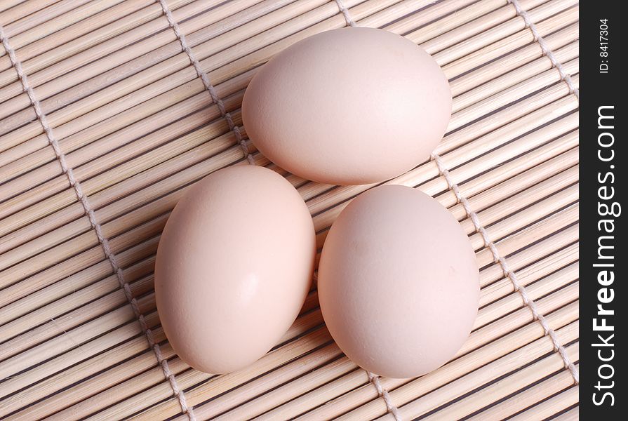 Three eggs lying down on bamboo chick