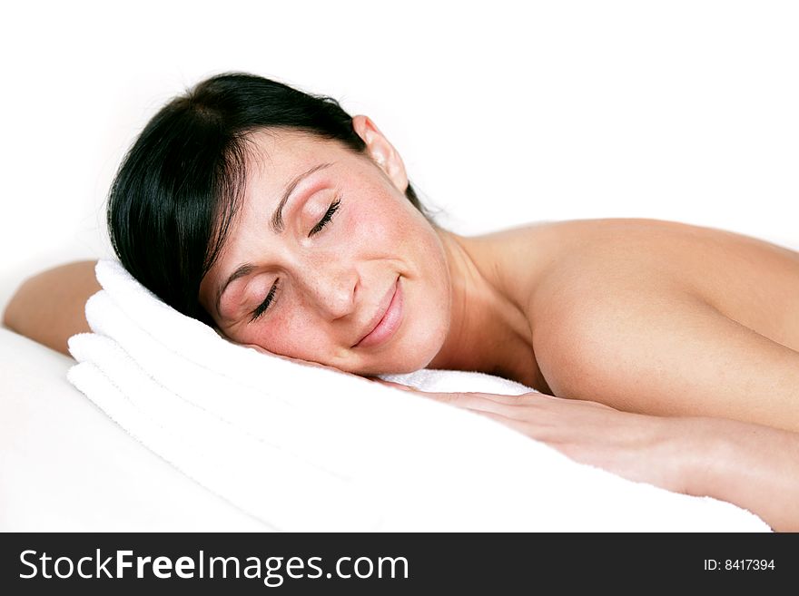 Relaxing spa girl lying on towel with closed eyes. Relaxing spa girl lying on towel with closed eyes