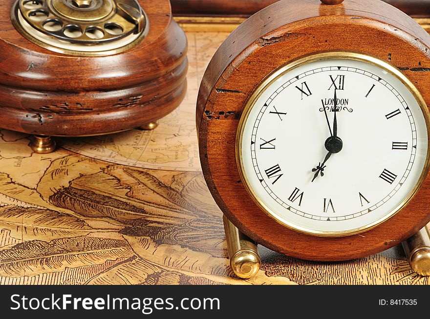 Old-fashion objects as background: wooden clock and telephone