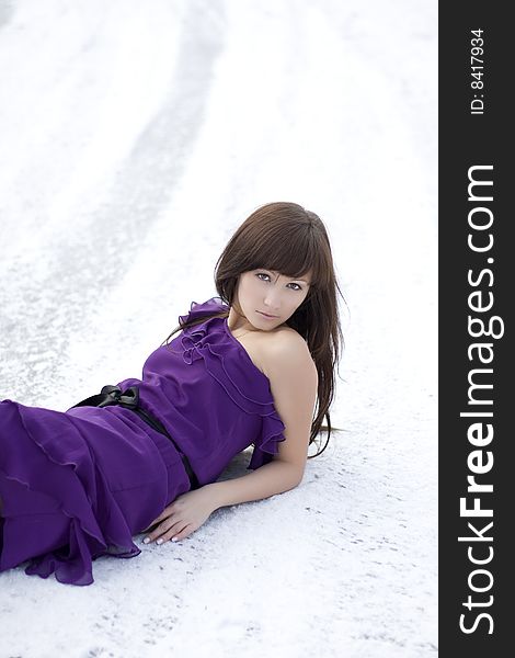 Girl Who Lies On The Snow In  Dress