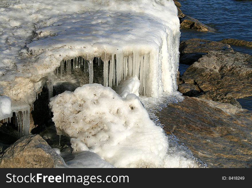 Icicles on the rocks on waterfront