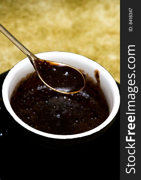 Black cup of chocolate with spoon