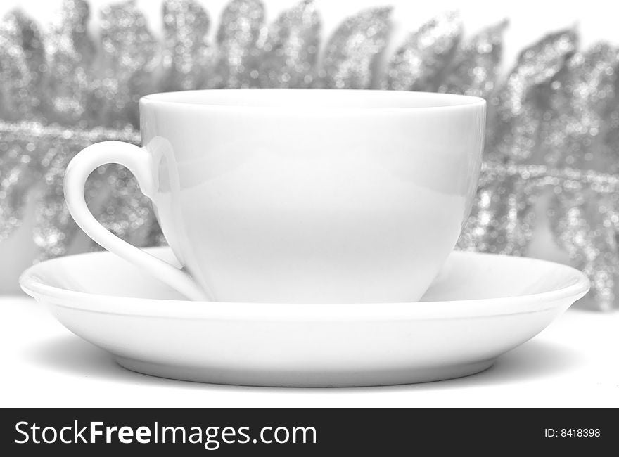 White cup of coffee with silver leaf