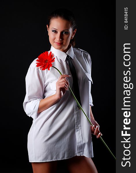 Beautiful young woman in white shirt with flower. Beautiful young woman in white shirt with flower