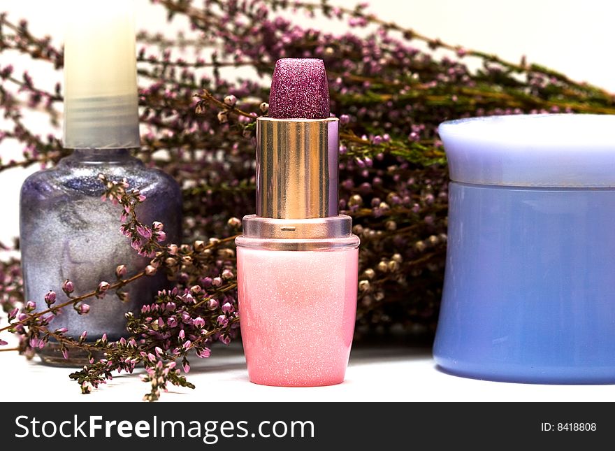 Cosmetics and flowers of lavender on white background