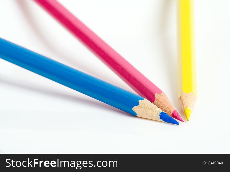 Cyan, magenta & yellow pencils on a white surface. May be used as abstract symbol of color separation in prepress. Cyan, magenta & yellow pencils on a white surface. May be used as abstract symbol of color separation in prepress