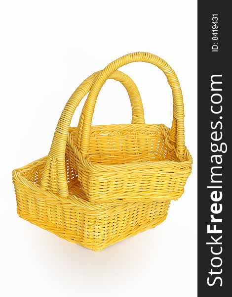 Two nice yellow wicker baskets isolated on white background