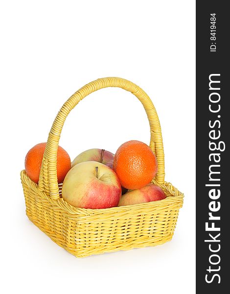 Nice yellow wicker basket with fruits isolated on white