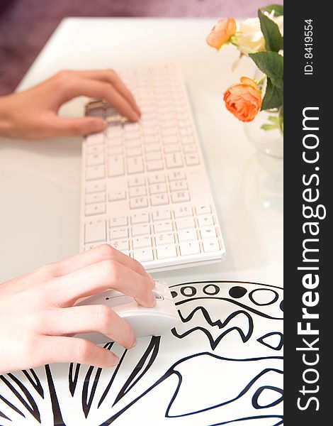 Businesswoman working on white keyboard and mouse