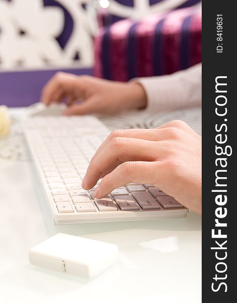 Businesswoman working on white keyboard and mouse