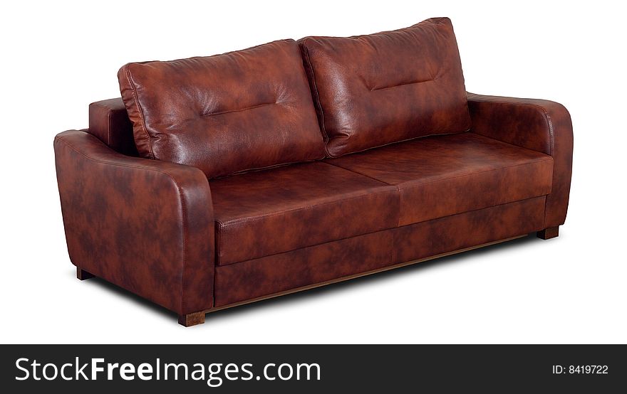 A small leather sofa with pillow isolated on a white background.