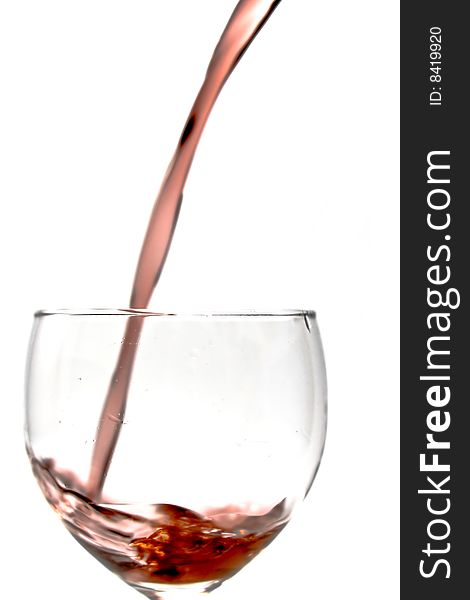 Pouring wine into a glass on a white background. Pouring wine into a glass on a white background