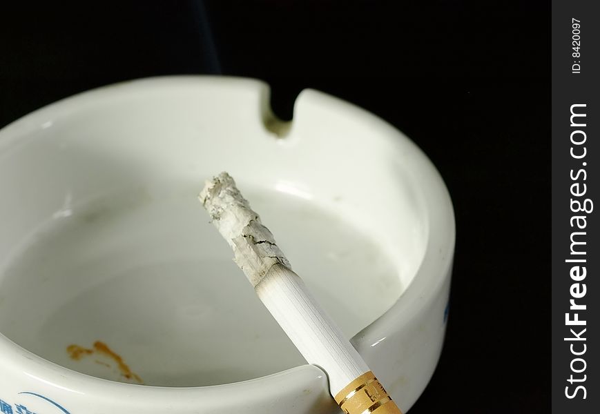 Burning cigarette in an ashtray