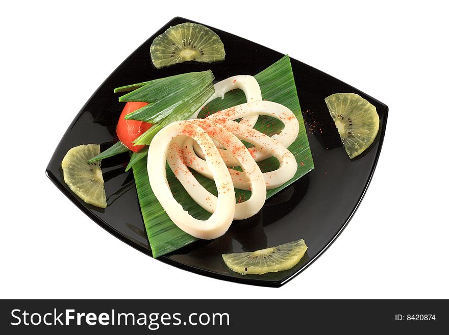 Rings of squid on black plate