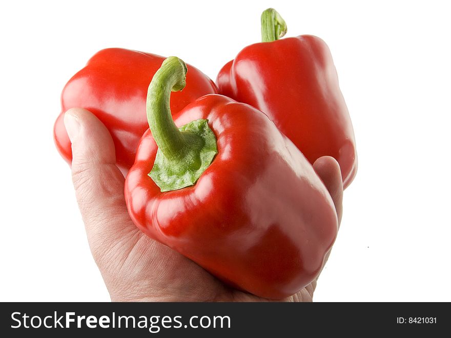 There are a red sweet peppers on the white background. There are a red sweet peppers on the white background