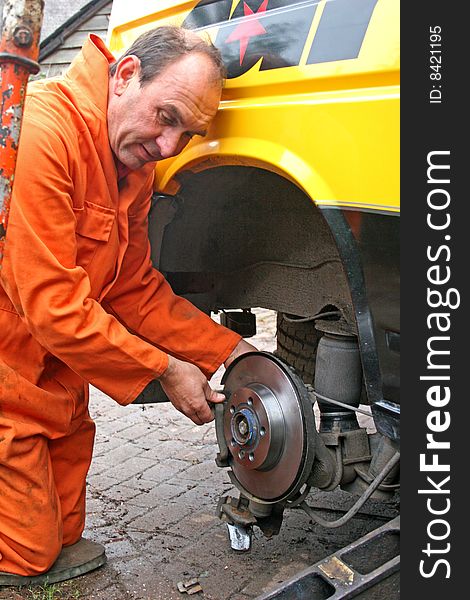 Engineer changing brake disc on van