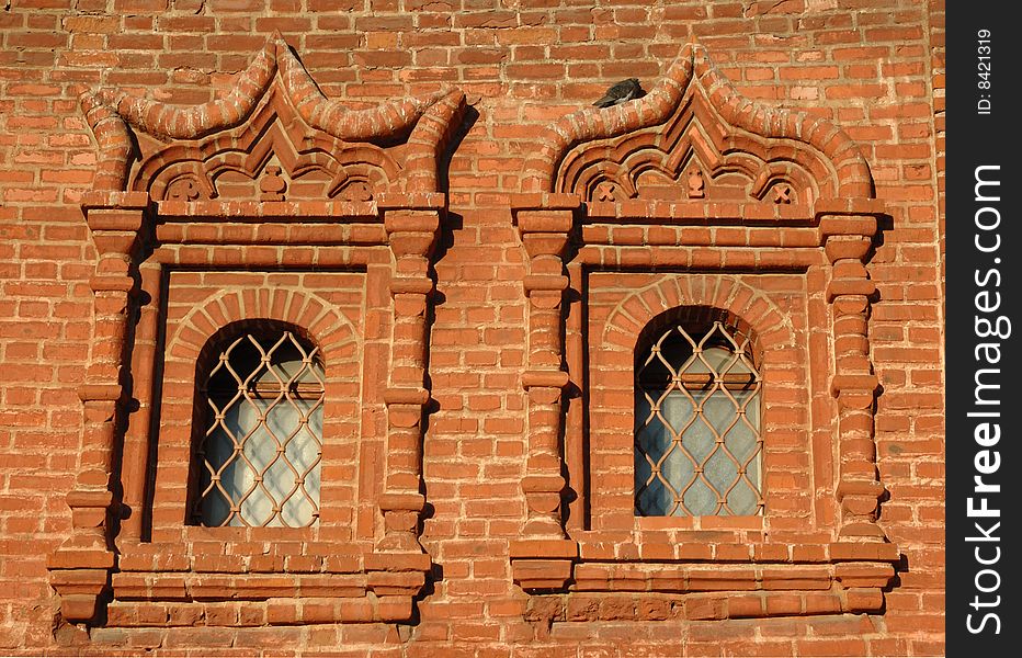 Two old windows on brickwall