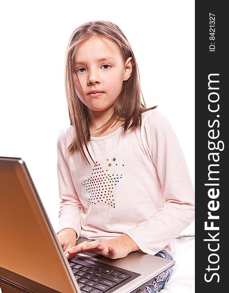 Studio photo of little girl with laptop