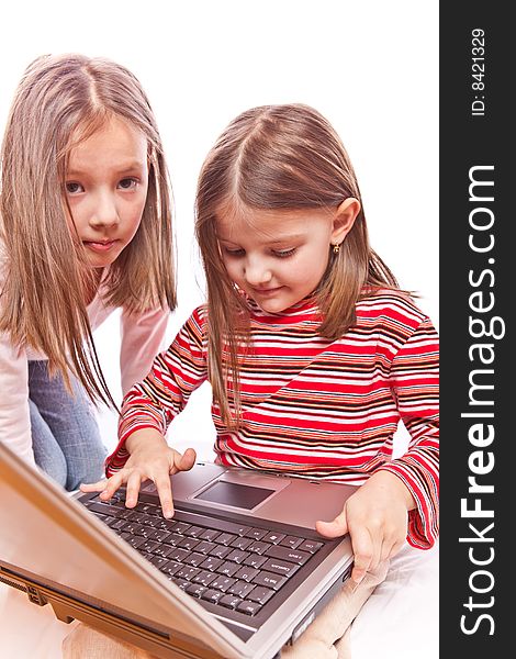 Studio photo of little girls with laptop