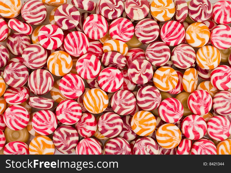 Round multi-coloured sweets as a background