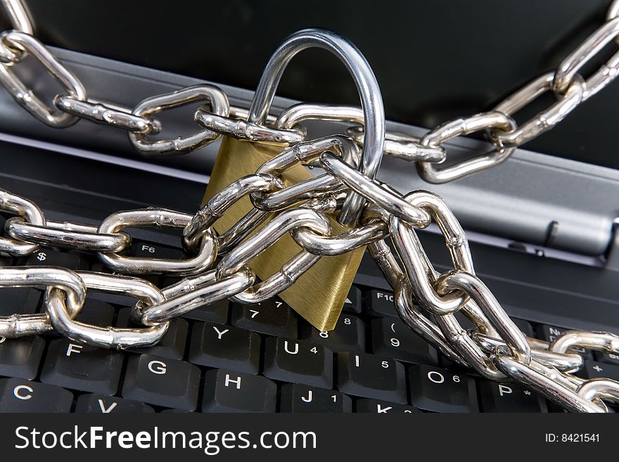 Laptop keyboard secured with chain and padlock