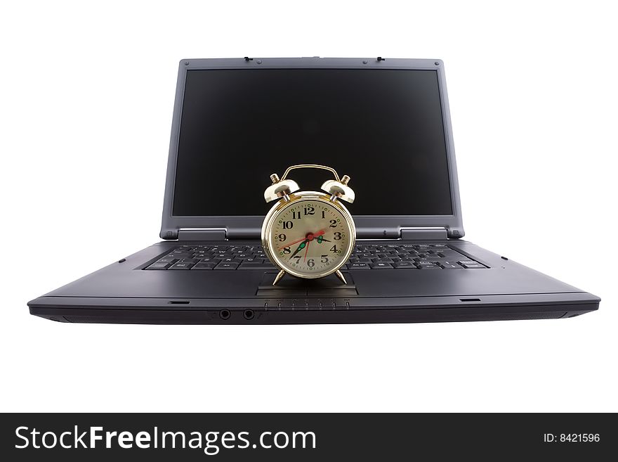 Black laptop and alarm clock. Black laptop and alarm clock