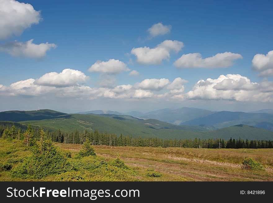 Mountain landscape with fluffy clouds