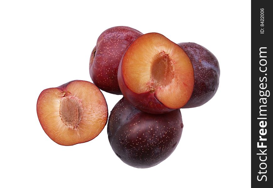 Whole plums and half on white background