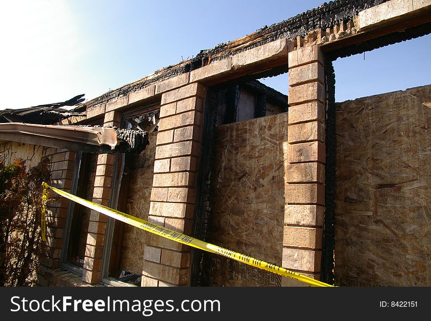 The remaining shell of a home destroyed by fire. The remaining shell of a home destroyed by fire.