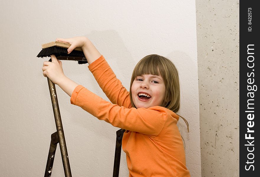 A little girl is playing on a step-ladder. A little girl is playing on a step-ladder