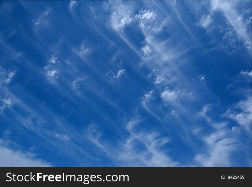 A blue sky with stripes and clouds