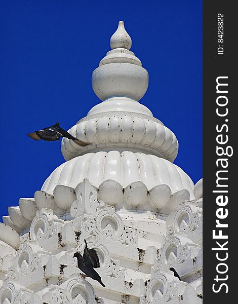 Detail of jain temple tower with clear blue sky background
