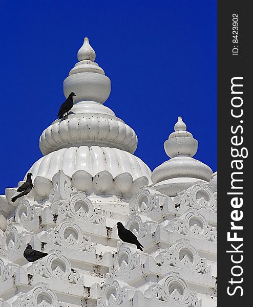 Detail of jain temple tower with clear blue sky background